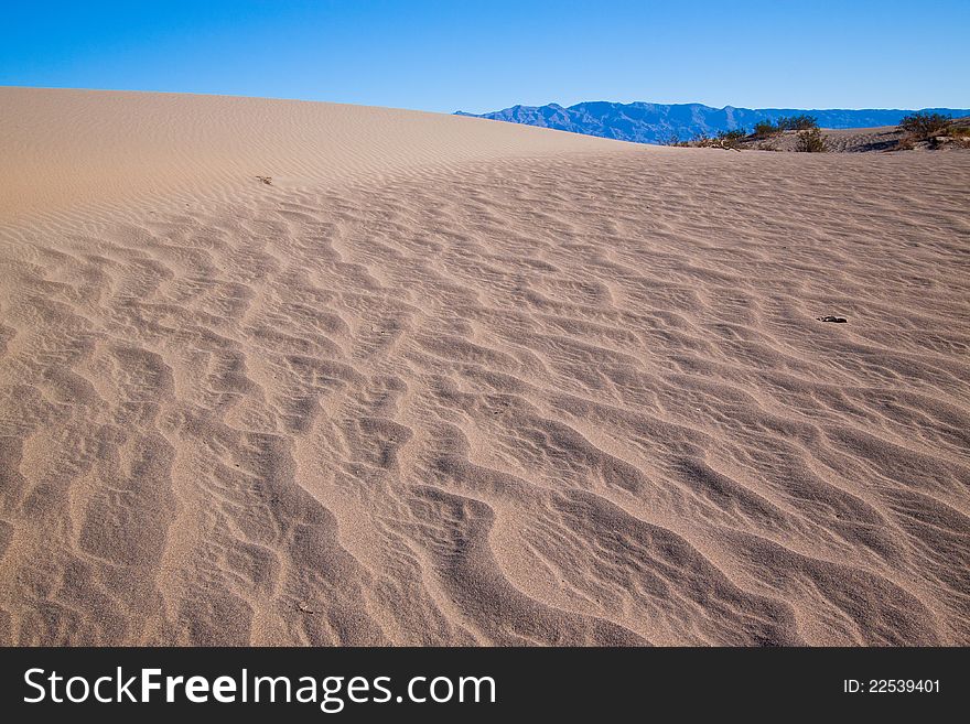 This image captures the intricate patterns of the Mesquite sand dunes in Death Valley National Park. This image captures the intricate patterns of the Mesquite sand dunes in Death Valley National Park.