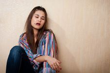 Depressed Woman Sitting By The Wall Stock Photo Depressed Woman Sitting By The Wall Stock Photo