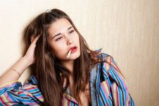 Depressed Woman Sitting By The Wall Stock Photo