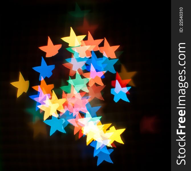 Christmas tree garland creates a multi-colored star bokeh.