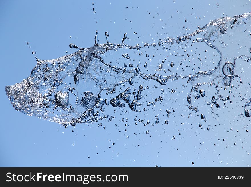 Freeze water fountain against blue sky