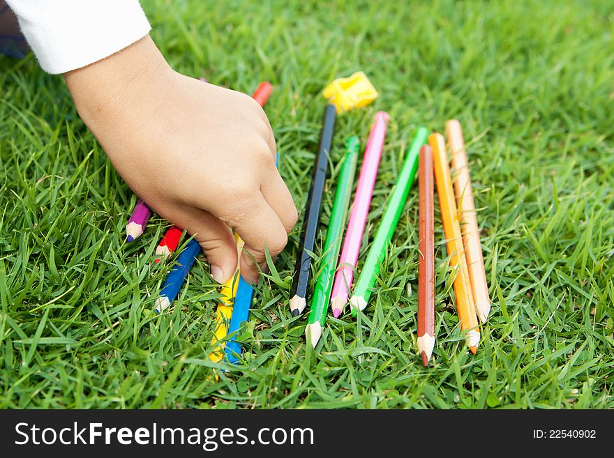 Children's hand picks colored pencil. Children's hand picks colored pencil