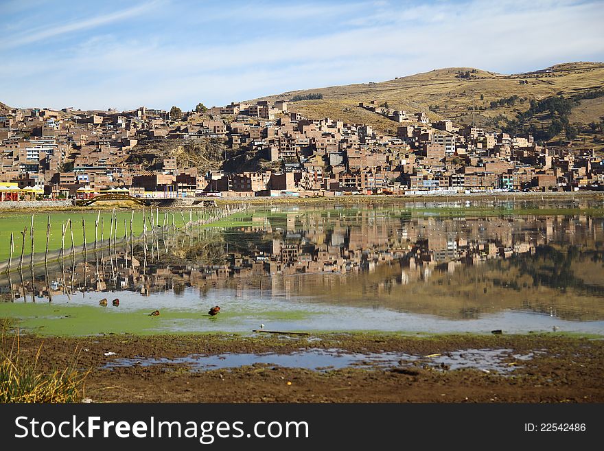 The Reflection of the city of Puno in the Titicaca lake, Peru. The Reflection of the city of Puno in the Titicaca lake, Peru