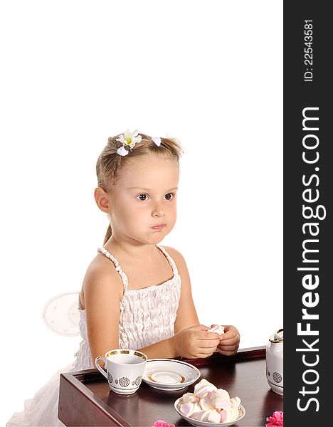 Nice little princess in beautiful white dress having tea with zephyr on white background. Nice little princess in beautiful white dress having tea with zephyr on white background