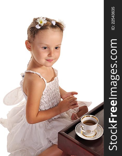 Nice little princess in beautiful white dress ans hazel eyes  having tea with zephyr  isolated on white background. Nice little princess in beautiful white dress ans hazel eyes  having tea with zephyr  isolated on white background