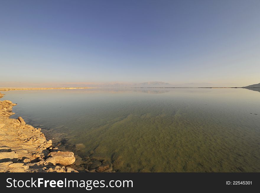 Calm surface of Dead Sea in winter and Jordan coast in the distance. Calm surface of Dead Sea in winter and Jordan coast in the distance.