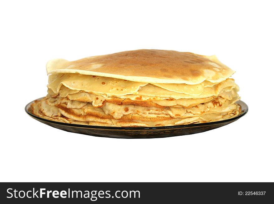 A stack of Russian thin pancakes on a dark plate isolated on white. A stack of Russian thin pancakes on a dark plate isolated on white