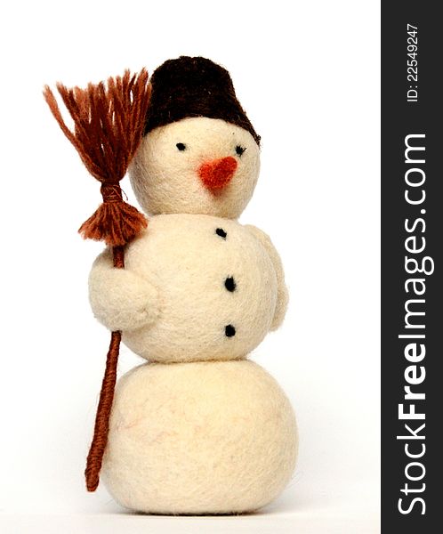 Toy - a cheerful snowman with broom on white background, close-up. Toy - a cheerful snowman with broom on white background, close-up