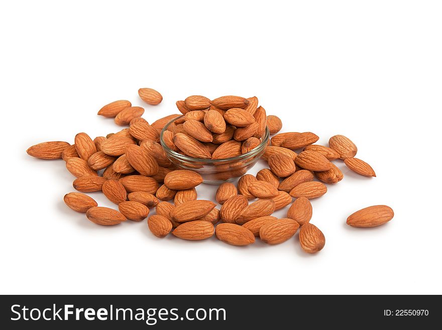 Pile of  almond and glass bowls isolated over white background. Pile of  almond and glass bowls isolated over white background