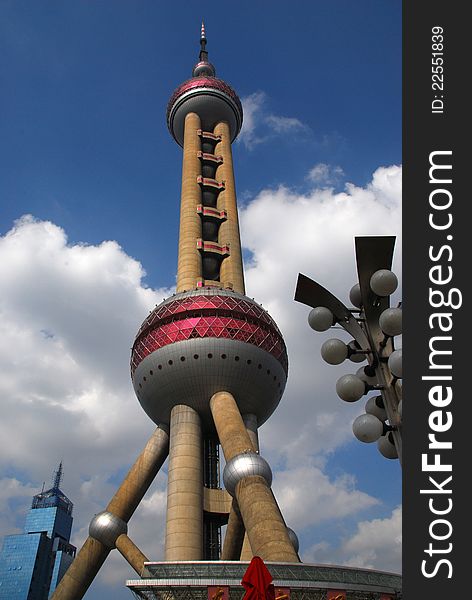 View looking up the Oriental Pearl Tower with blue sky and clouds background. View looking up the Oriental Pearl Tower with blue sky and clouds background