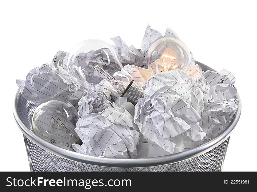 Illuminated bulb in waste bin with screwed up paper on white background. Illuminated bulb in waste bin with screwed up paper on white background