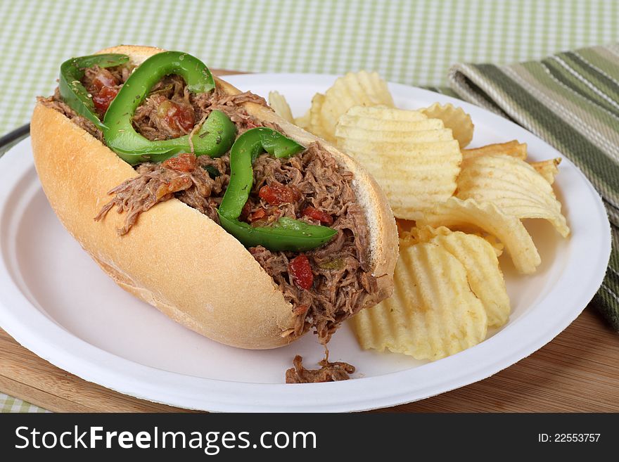 Shredded roast beef and green pepper sandwich with chips. Shredded roast beef and green pepper sandwich with chips