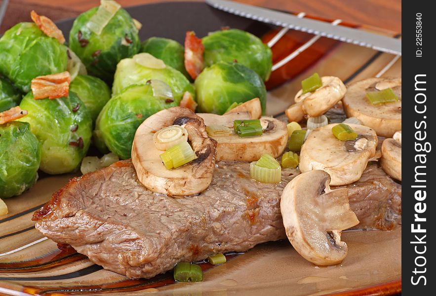 Steak dinner with mushrooms and brussels sprouts. Steak dinner with mushrooms and brussels sprouts
