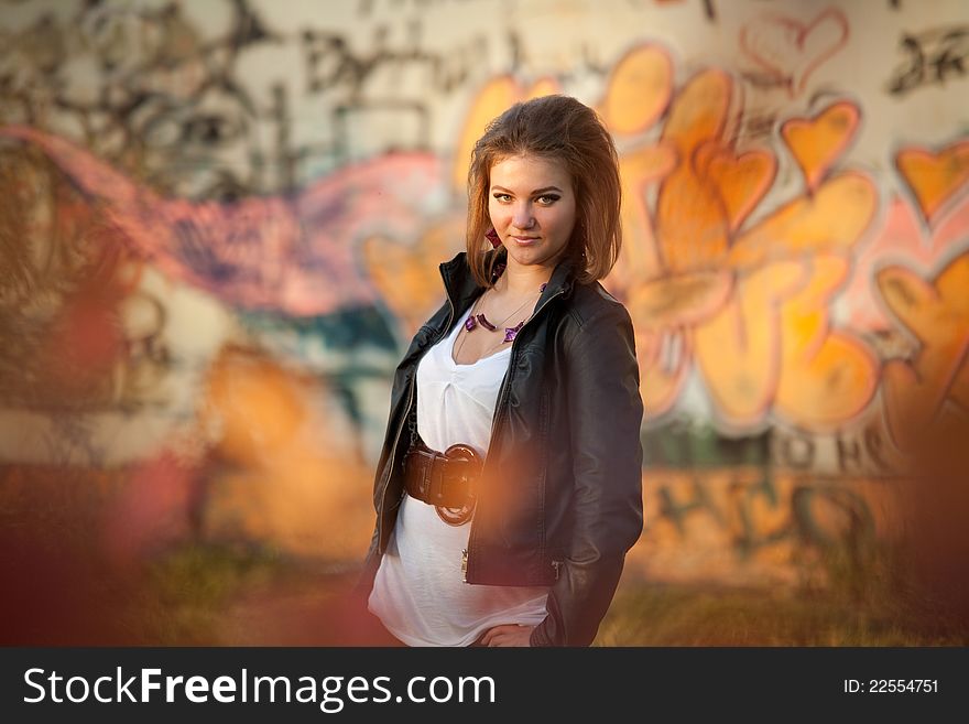 Urban portrait of the girl on the background graffiti. Urban portrait of the girl on the background graffiti