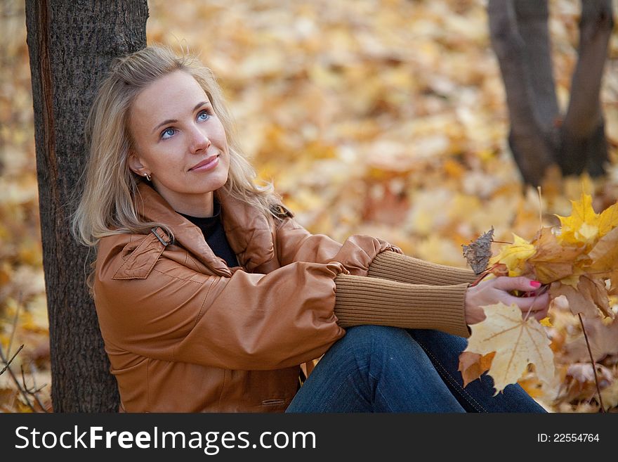 The girl on a walk in the autumn park