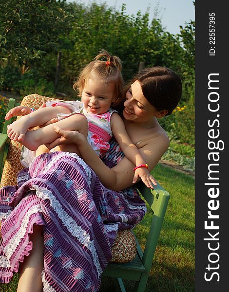 Mother and daughter playing together in the garden