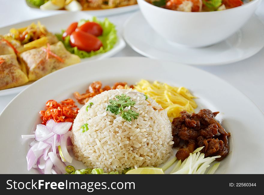 Mixed cooked rice with shrimp paste sauce and fresh vegetable , Thai food on table