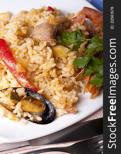 Dish of paella rice with prawns and chunks of meat