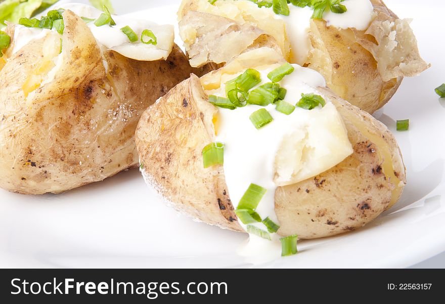 Delicious baked potatoes on a white background