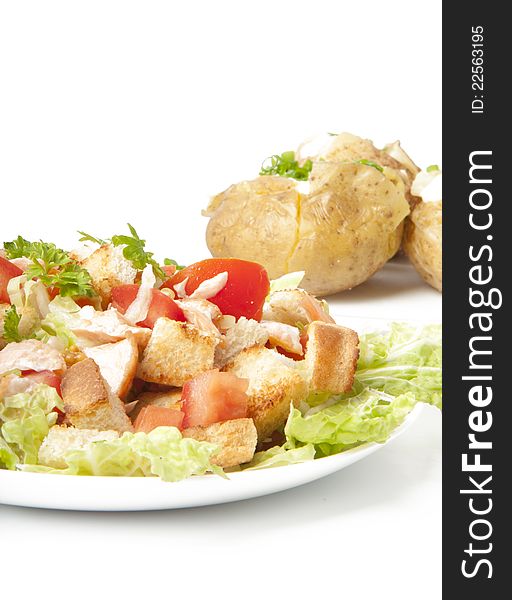 Delicious salad and baked potatoes on a white background