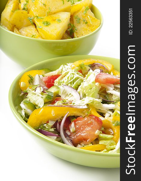 A delicious salad and boiled potatoes on a white background