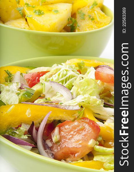 A delicious salad and boiled potatoes on a white background