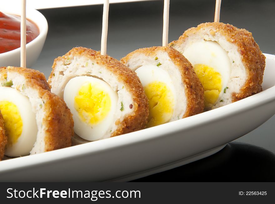 Meatballs with quail eggs and potatoes on a white background