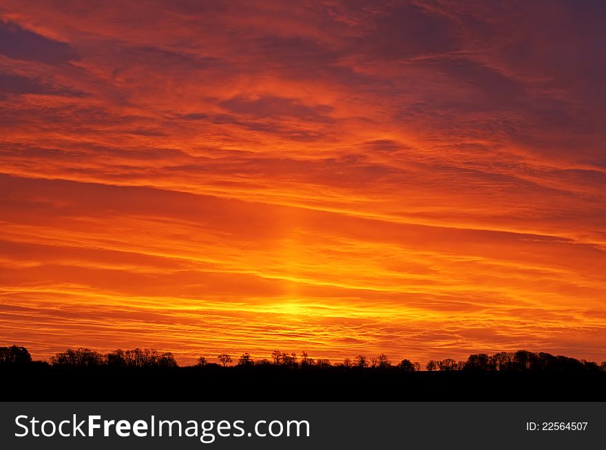 A sunrise on Christmas Eve with the morning sky a mix of colours including salmon pink with various shades of yellow, red and orange. A sunrise on Christmas Eve with the morning sky a mix of colours including salmon pink with various shades of yellow, red and orange.