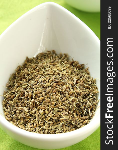 Close-up of dry anise seeds in a white bowl