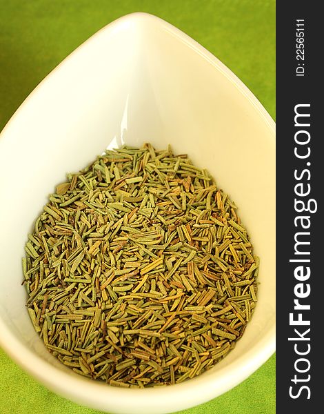 Close-up of dry rosemary in a white bowl