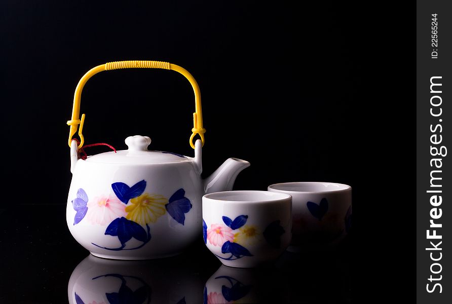 White porcelain teapot on a black background