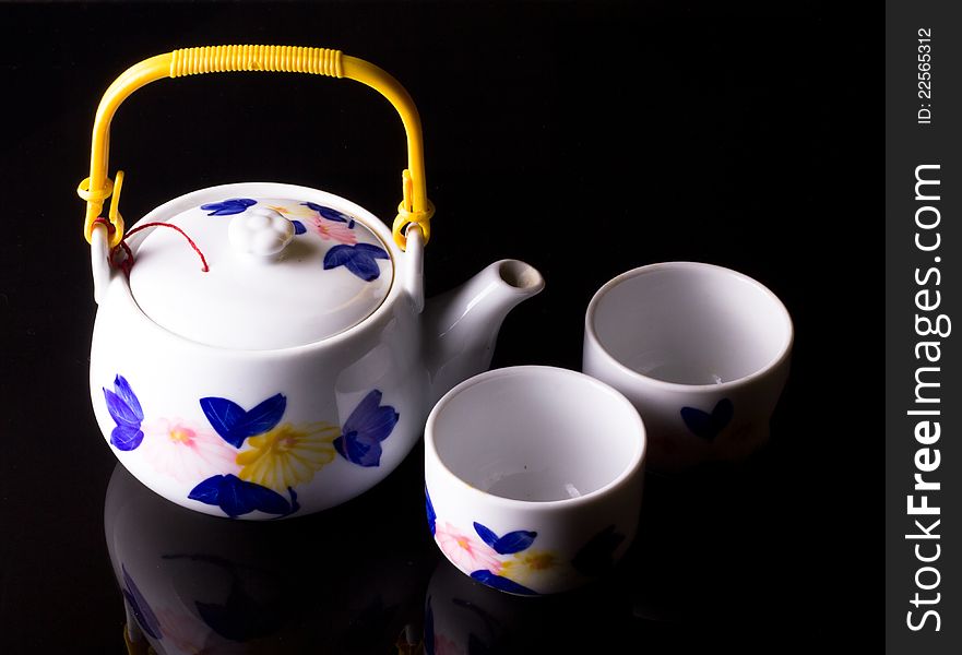 White porcelain teapot on a black background