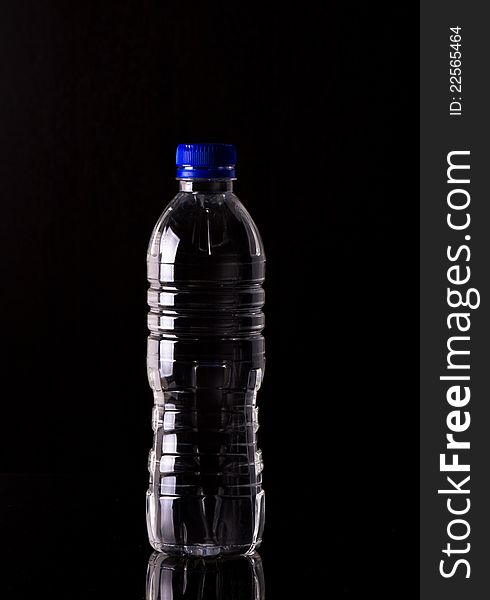 Pure Water in the bottle on black background. Pure Water in the bottle on black background
