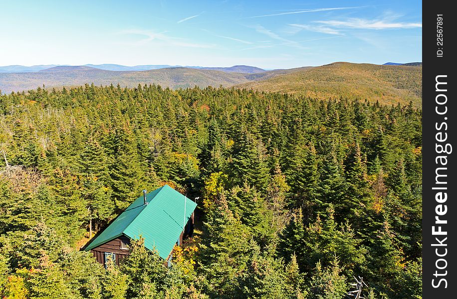 A view of a cabin from the Balsam Lake Mountain fire tower in early autumn in the Catskills Mountains of New York. A view of a cabin from the Balsam Lake Mountain fire tower in early autumn in the Catskills Mountains of New York