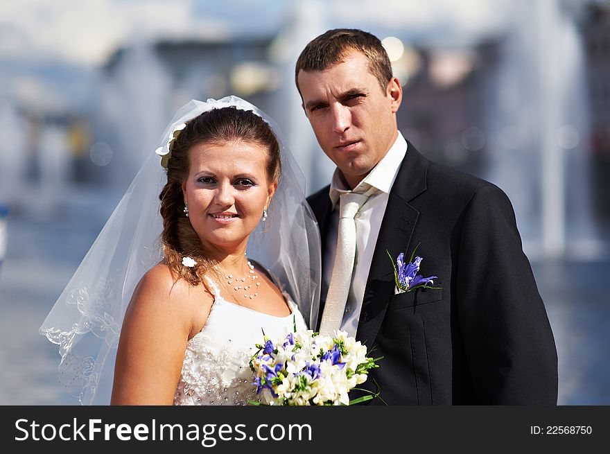 Happy bride and groom with bouquet