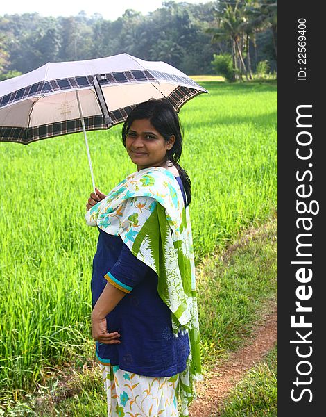 Indian Village Girl Holding Umbrella In Sunlight