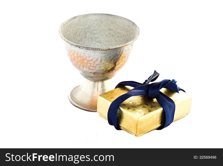 Golden gift box and old metal sneezer over white background.