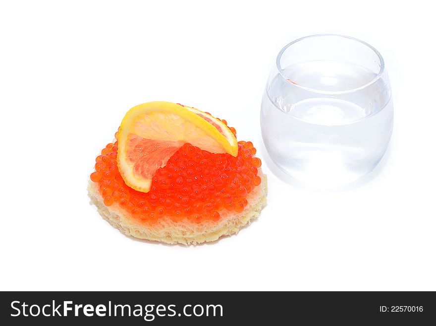 Bread with red caviar and glass of vodka isolated on white. Bread with red caviar and glass of vodka isolated on white