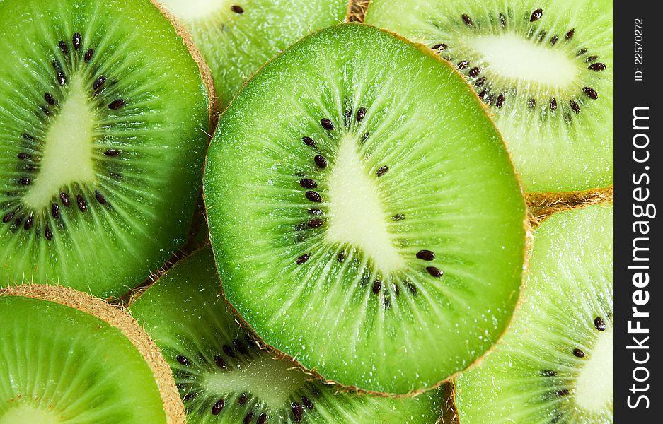 Bright green kiwi slices background