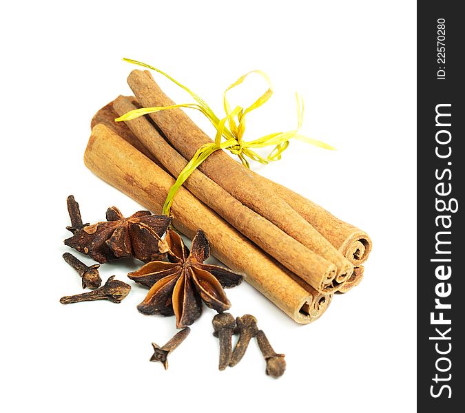 Cinnamon sticks, star anise, and cloves on a white background. Cinnamon sticks, star anise, and cloves on a white background