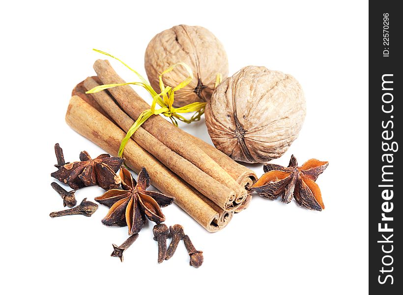 Cinnamon sticks, star anise, walnuts and cloves on a white background. Cinnamon sticks, star anise, walnuts and cloves on a white background