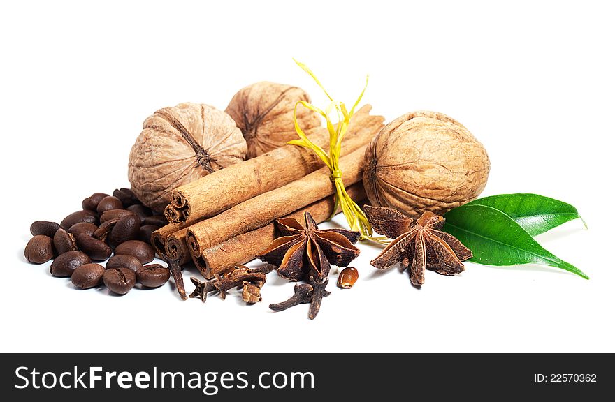Cinnamon sticks, star anise,  walnuts and cloves on a white background. Cinnamon sticks, star anise,  walnuts and cloves on a white background