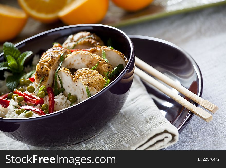 Photograph of a bowl of rice with vegetables and chicken. Photograph of a bowl of rice with vegetables and chicken