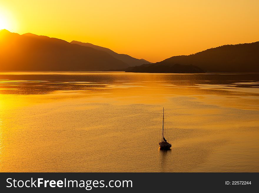 Lonely Boat In The Sea On Sunrise