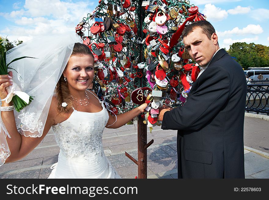 Happy Bride And Groom About Padlocks Tree