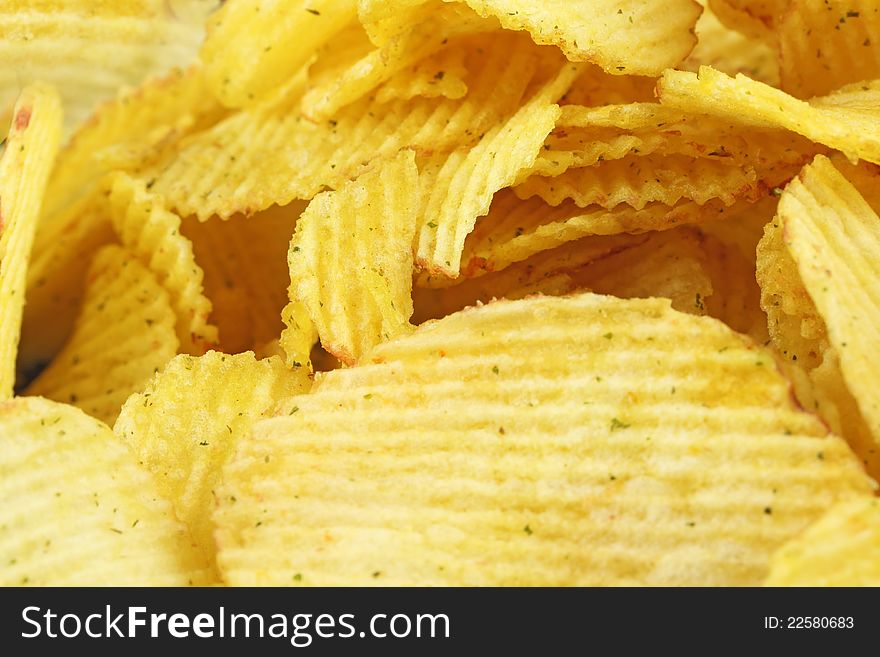 Corrugated potato chips close up. Corrugated potato chips close up.