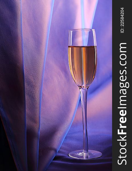 Celebratory glass of champagne on a dark blue background