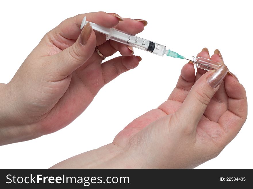 Woman hands filling a syringe against white background