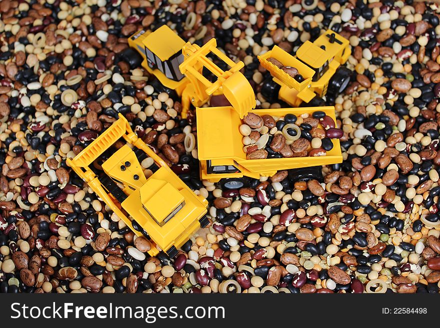 Toy trucks working a landscape of beans