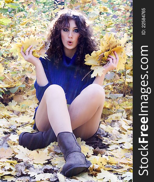 Young happy woman against the backdrop of autumn foliage yellow. Young happy woman against the backdrop of autumn foliage yellow.